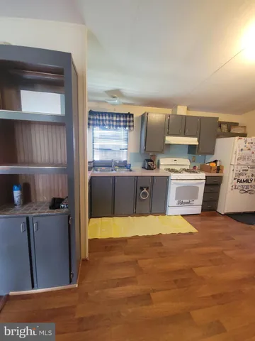 a large kitchen with stainless steel appliances granite countertop a stove and a refrigerator