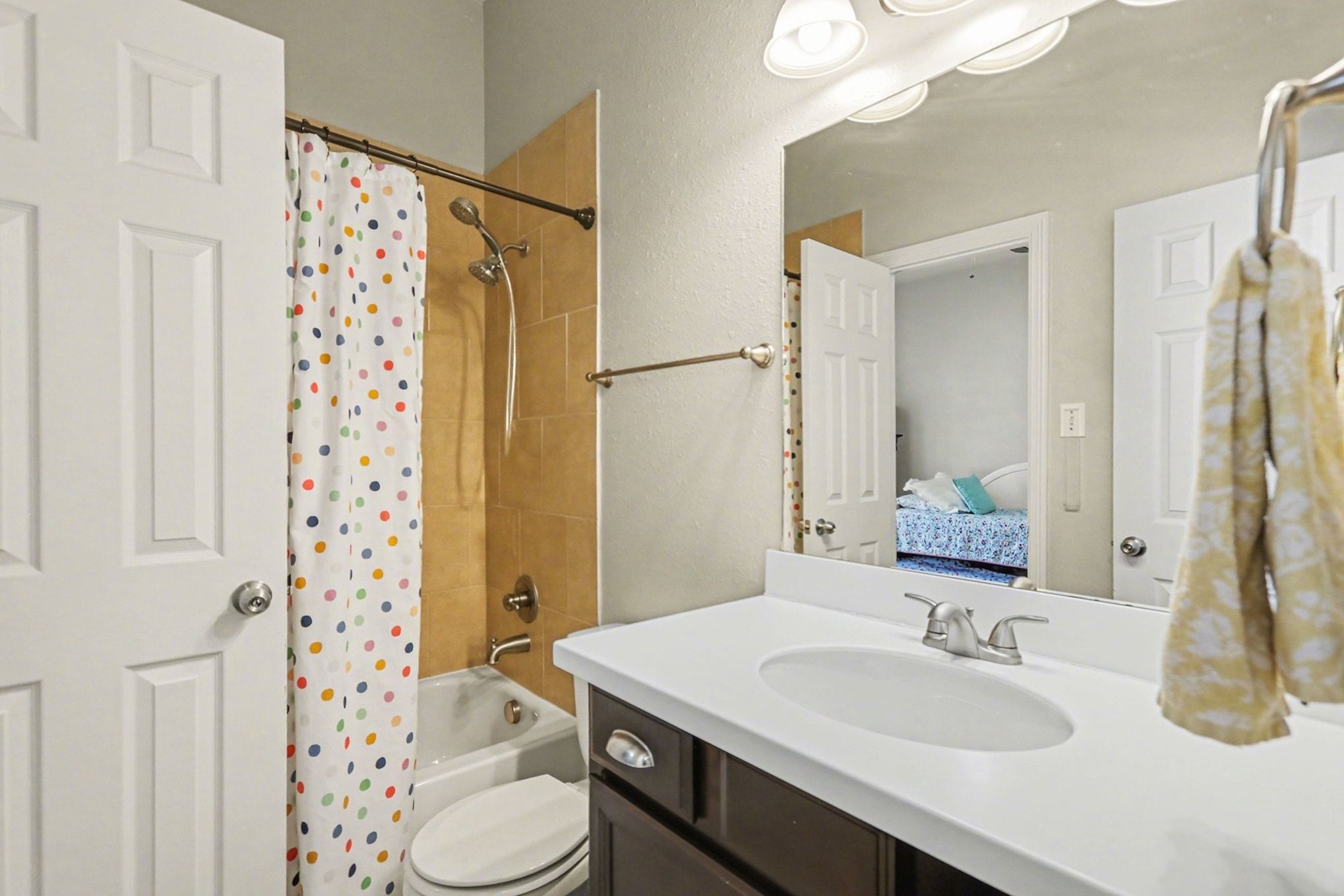 27006 Cliff Pointe Lane Katy, TX 77494 - Photo 26 of 34 Full secondary bath with extended vanity, tile tub surround, and updated lighting—conveniently located for nearby bedrooms.