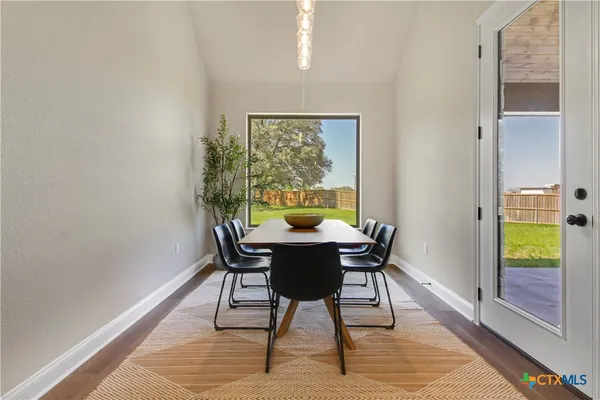 a dining room with furniture and wooden floor