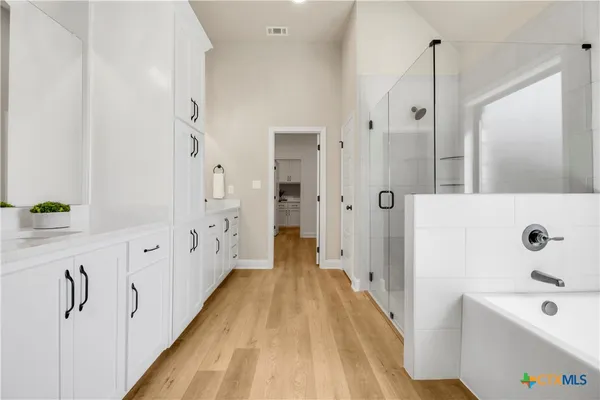 a spacious bathroom with a bathtub and a shower