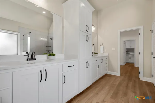 a bathroom with a double vanity sink and mirror