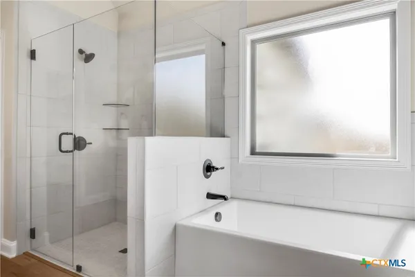 a bathroom with a bathtub and a shower