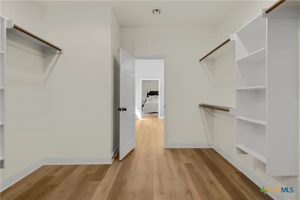 a view of hallway with wooden floor