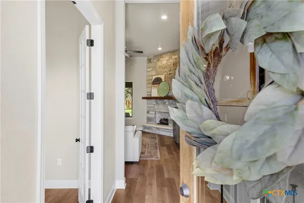 a kitchen with a sink a refrigerator and wooden floor