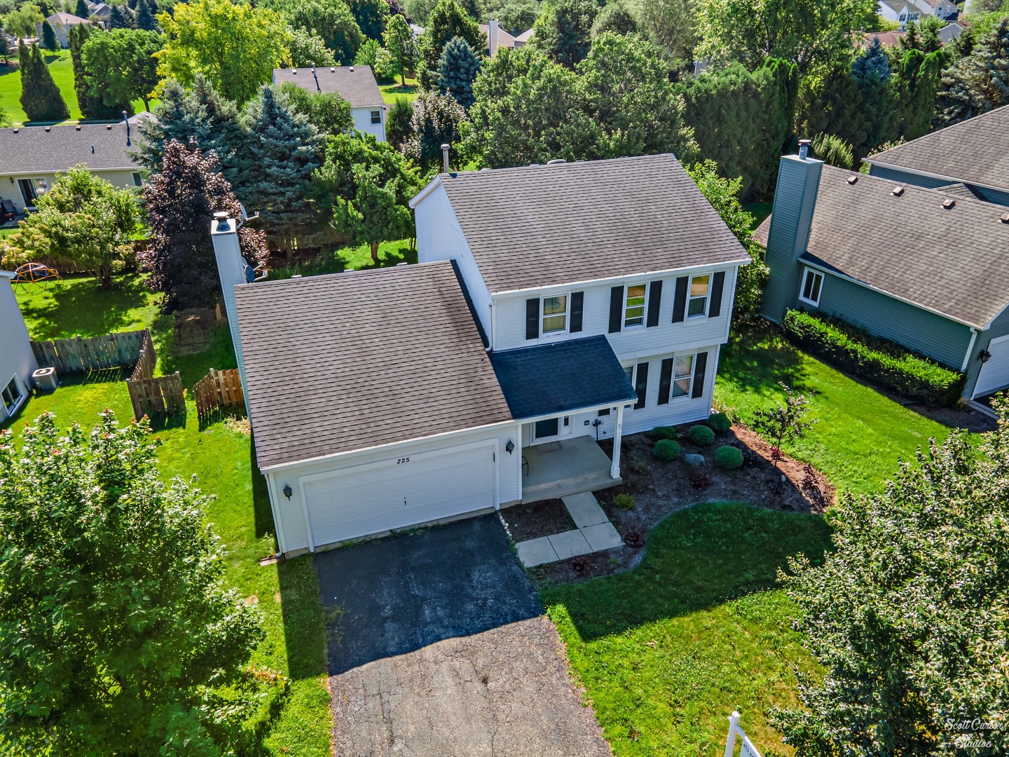 an aerial view of a house with garden space and sitting area