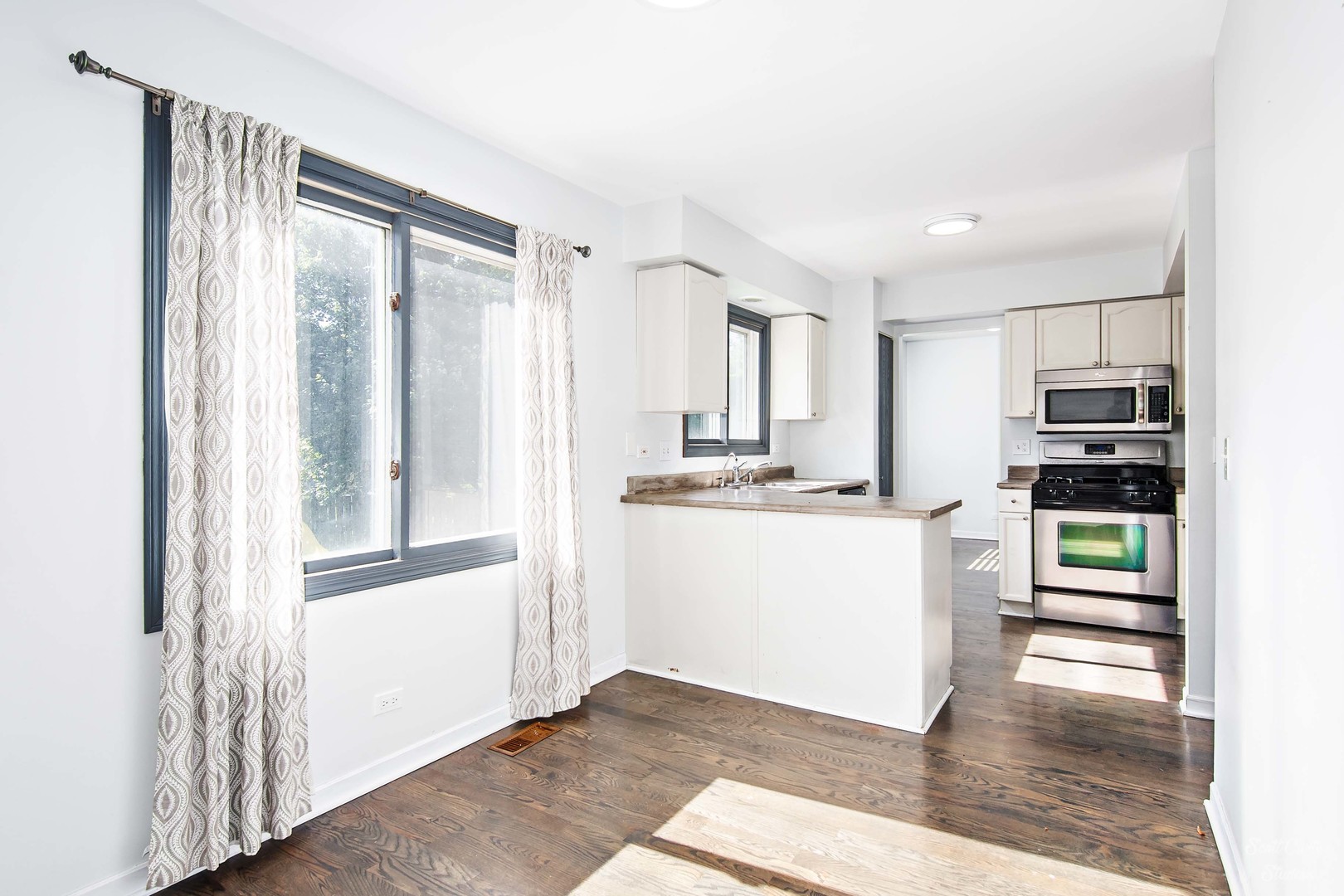 225 Sierra Trail Cary, IL 60013 - Photo 14 of 23 a kitchen with a refrigerator and white cabinets