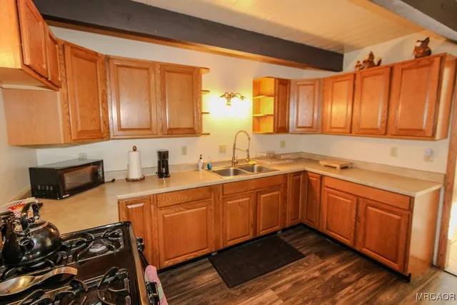 a kitchen with a sink stove and cabinets