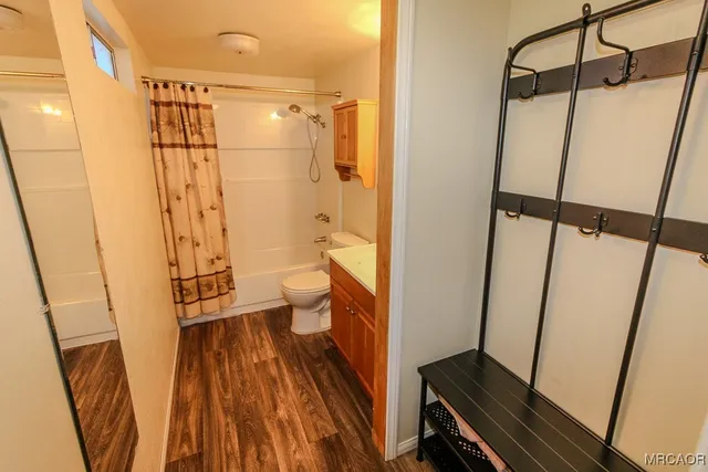 a bathroom with a shower toilet and sink