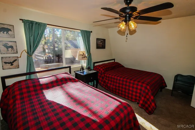 a bedroom with a bed lamps and window