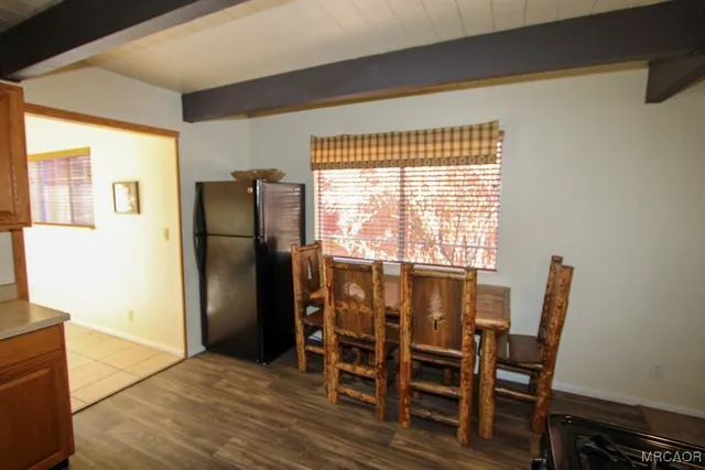 a view of a dining room with furniture and a window