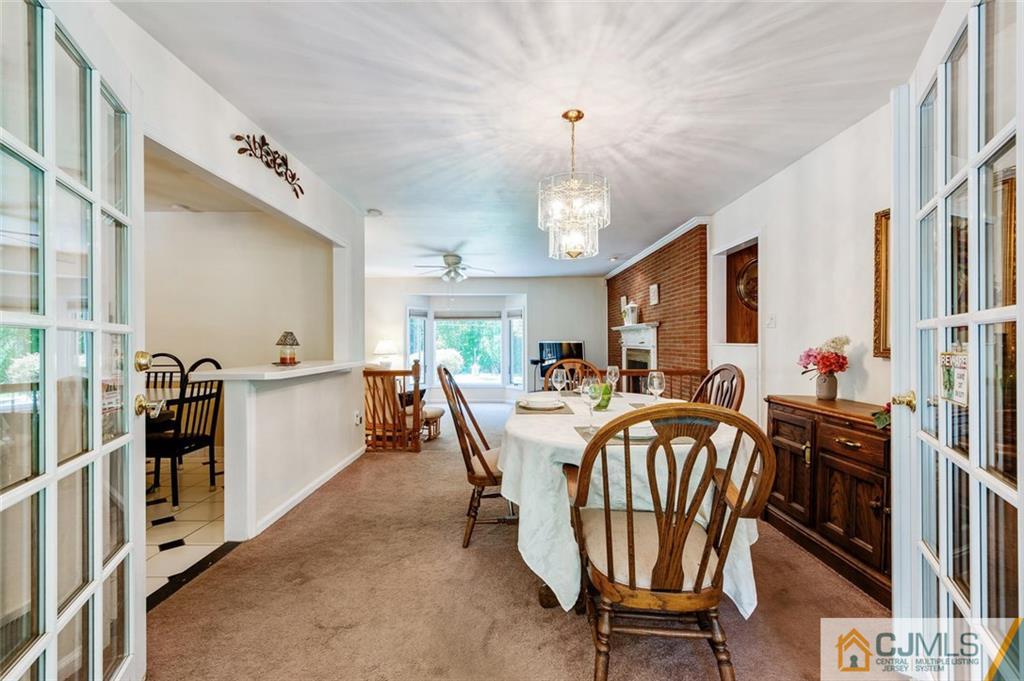 304 Fresh Ponds Road North Brunswick, NJ 08902 - Photo 13 of 44 a view of a dining room with furniture and a chandelier