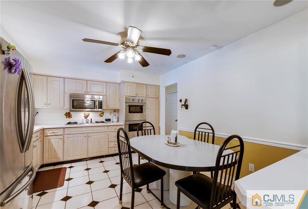 304 Fresh Ponds Road North Brunswick, NJ 08902 - Photo 14 of 44 a view of a dining room with furniture and a kitchen