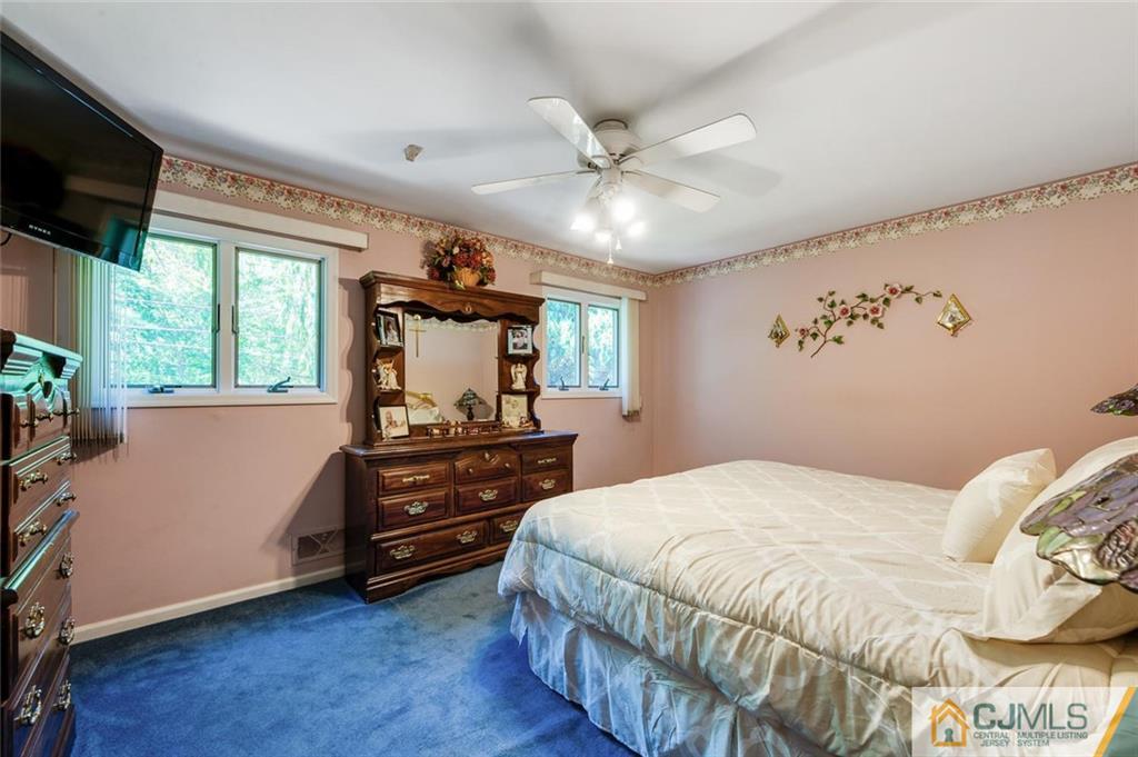 304 Fresh Ponds Road North Brunswick, NJ 08902 - Photo 19 of 44 a bedroom with a bed and a flat tv screen on dresser