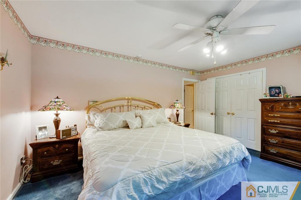 304 Fresh Ponds Road North Brunswick, NJ 08902 - Photo 20 of 44 a bedroom with a bed and a chandelier