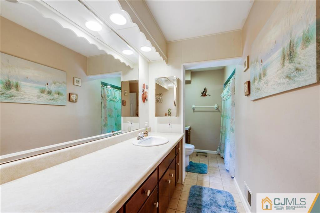 304 Fresh Ponds Road North Brunswick, NJ 08902 - Photo 21 of 44 a bathroom with a double vanity sink and a mirror