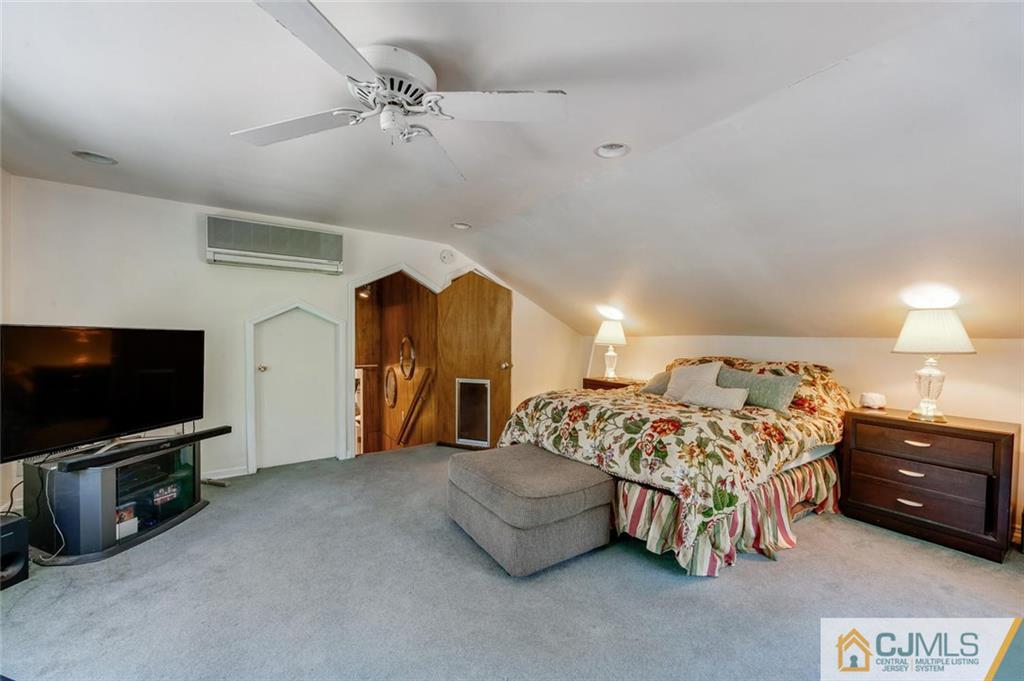 304 Fresh Ponds Road North Brunswick, NJ 08902 - Photo 22 of 44 a spacious bedroom with a bed and a flat screen tv