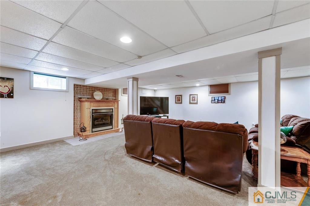 304 Fresh Ponds Road North Brunswick, NJ 08902 - Photo 28 of 44 a living room with furniture a fireplace and a flat screen tv