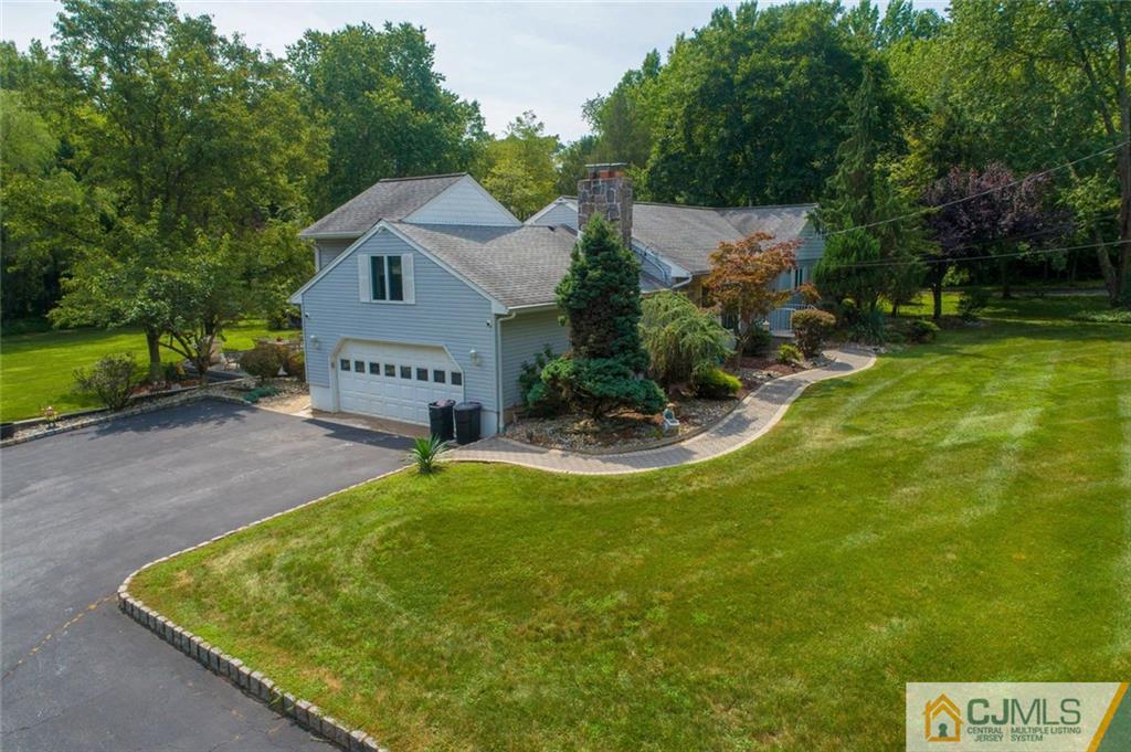 304 Fresh Ponds Road North Brunswick, NJ 08902 - Photo 40 of 44 a view of a house with a yard potted plants and large tree