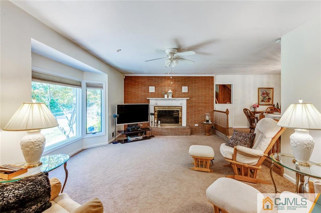 304 Fresh Ponds Road North Brunswick, NJ 08902 - Photo 7 of 44 a living room with furniture a flat screen tv and a large window