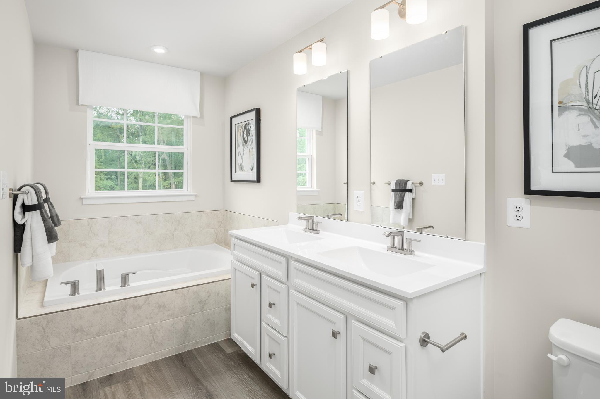 8428 Branch Side Way, Unit D Brandywine, MD 20613 - Photo 16 of 23 a bathroom with a tub sink and mirror