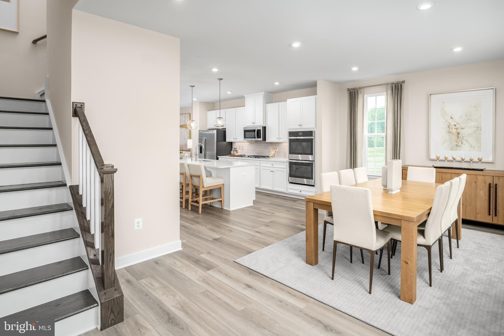 8428 Branch Side Way, Unit D Brandywine, MD 20613 - Photo 4 of 23 a view of a dining room with furniture and wooden floor