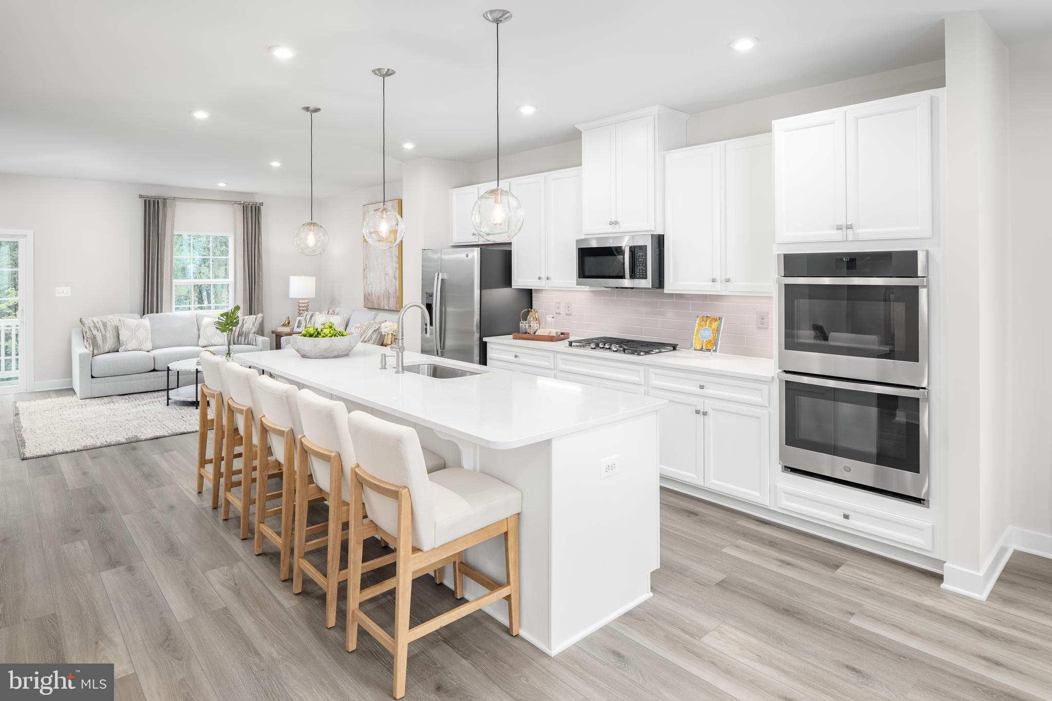 8428 Branch Side Way, Unit D Brandywine, MD 20613 - Photo 5 of 23 a kitchen with stainless steel appliances kitchen island granite countertop a stove a sink and a refrigerator