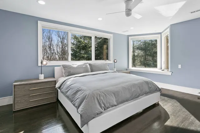 a bedroom with a bed lamp and window