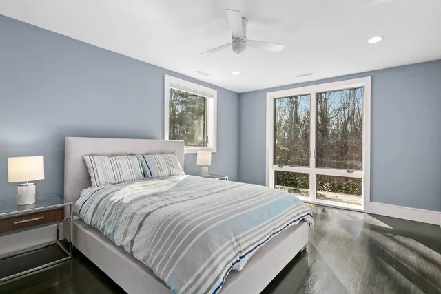 a bedroom with a large bed and a large window