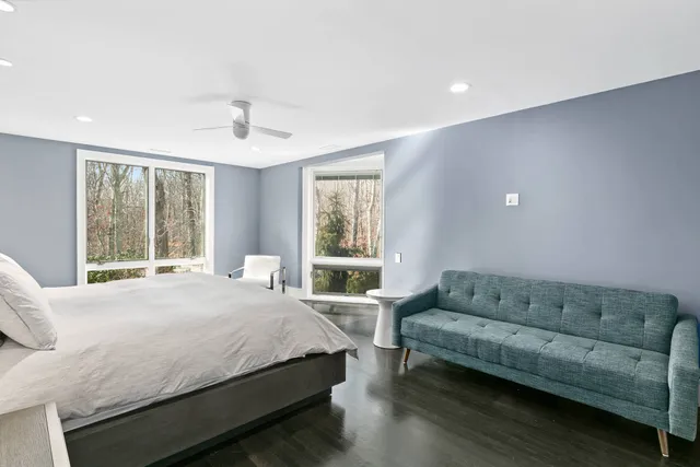 a bedroom with a bed couch and window