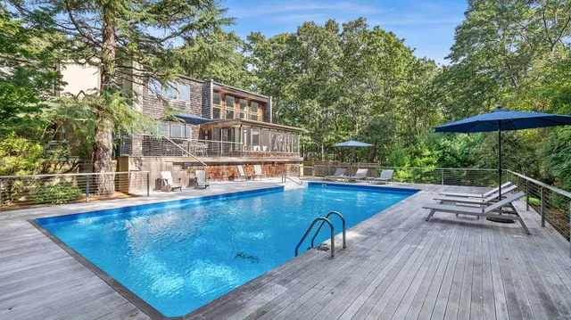 swimming pool view with a seating space and a garden view