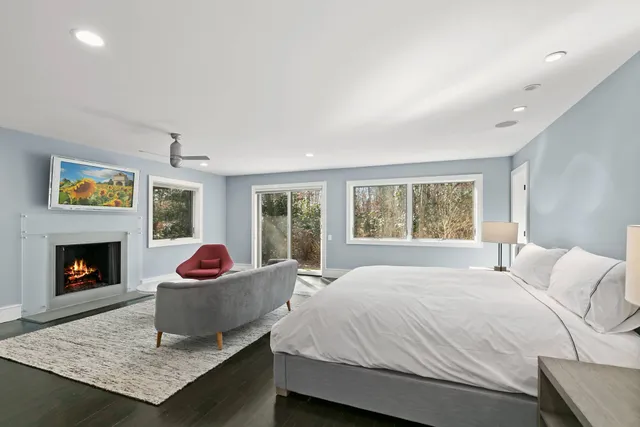 a bedroom with a bed and a fireplace