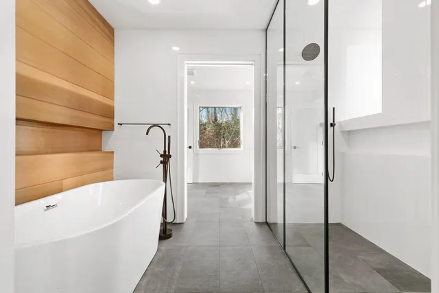 a bathroom with a bathtub and shower