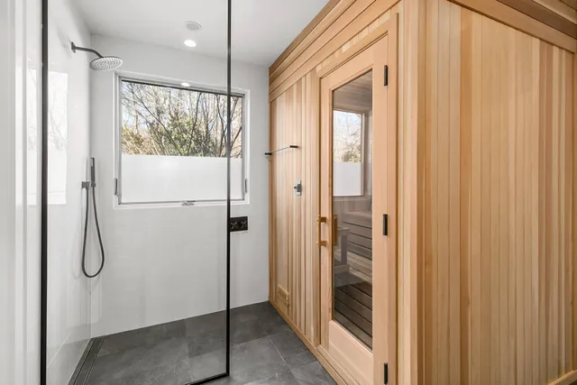 a bathroom with a shower and a window