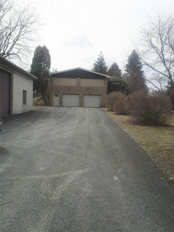 230 Leslie Road Valencia, PA 16059 - Photo 2 of 16 Partial Paved Security Driveway that leads to the large 2 car attached and the 5 car detached garage! Newer garage doors on integral! New Roof 2015 on detached garage!
