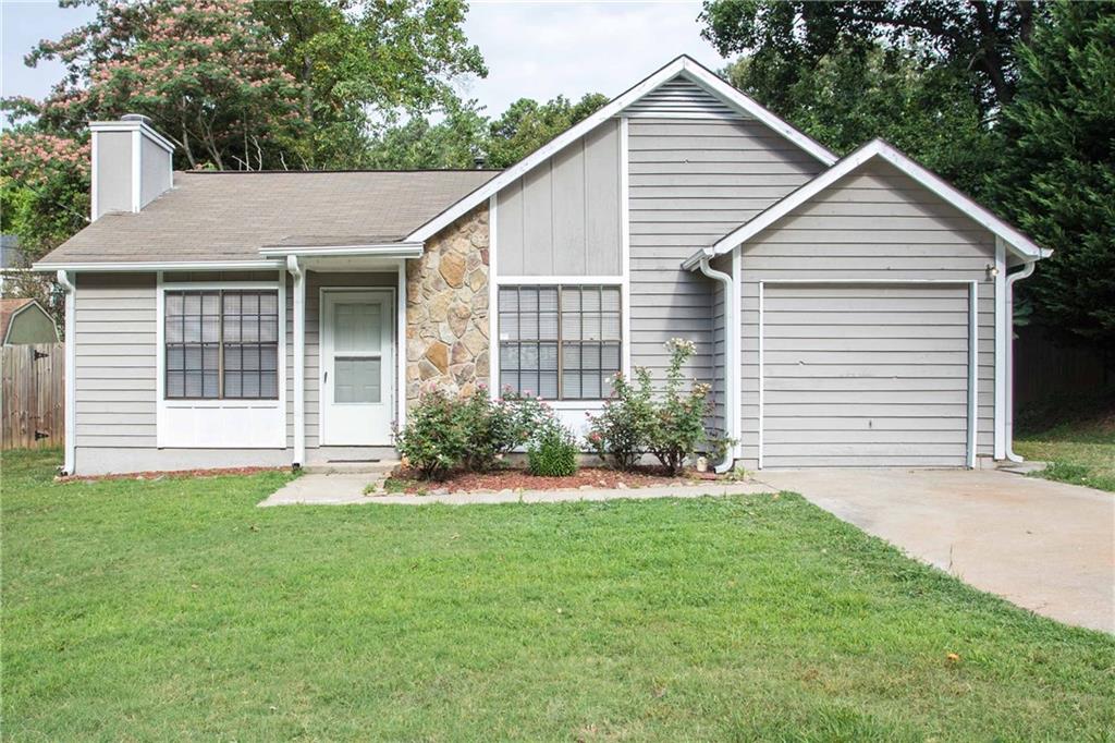 4167 Little Springs Road Kennesaw, GA 30144 - Photo 1 of 1 a view of a house with a yard plants and large tree