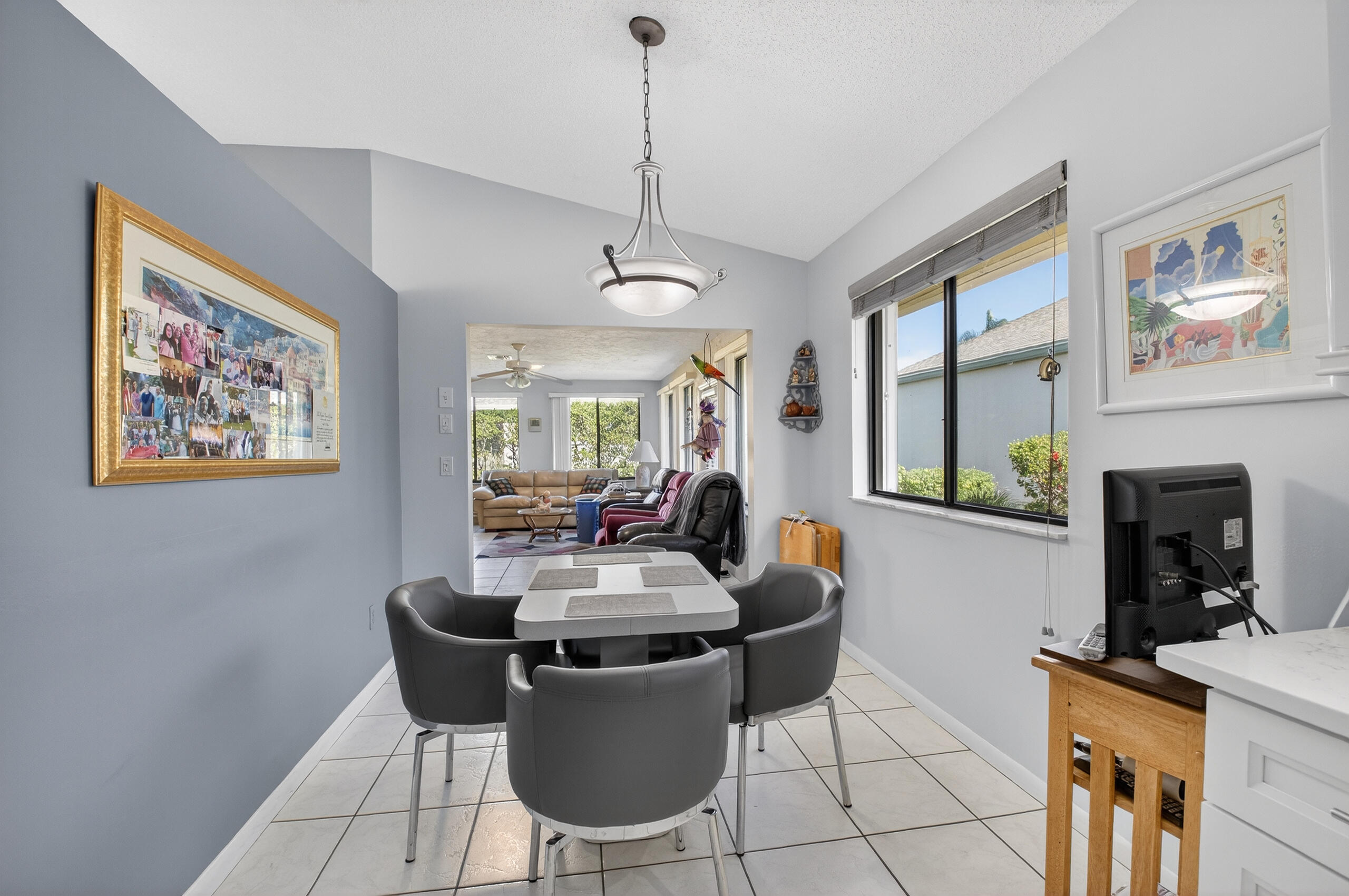 2601 Northwest 15th Street Delray Beach, FL 33445 - Photo 16 of 59 a dining room with furniture a window and wooden floor
