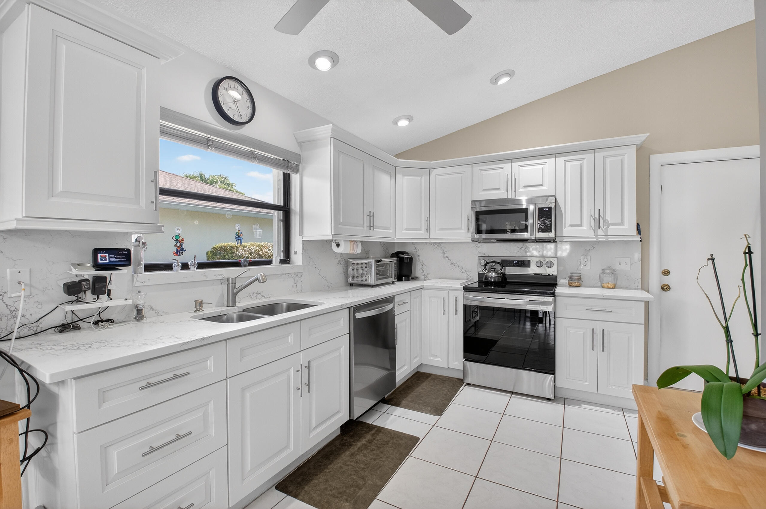 2601 Northwest 15th Street Delray Beach, FL 33445 - Photo 37 of 59 a kitchen with a sink cabinets and stainless steel appliances