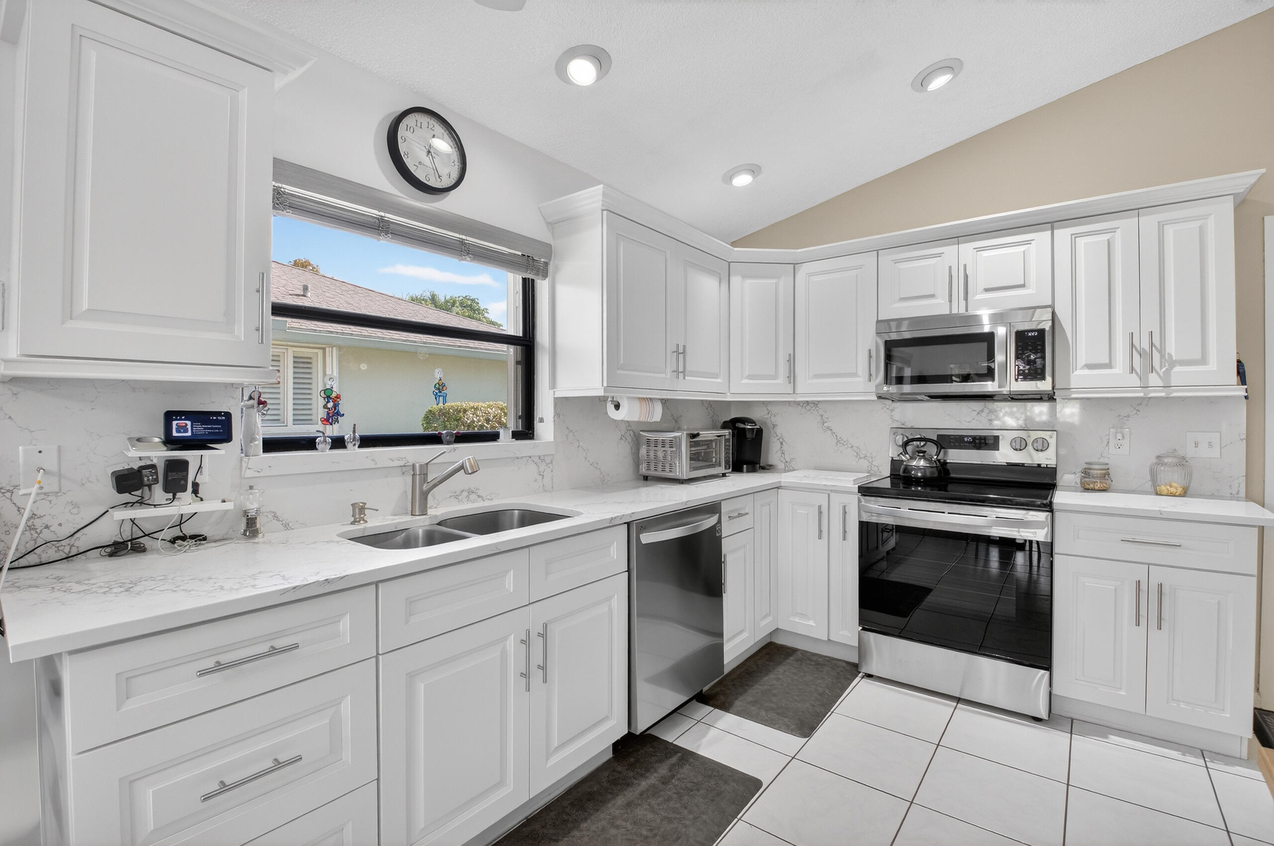 2601 Northwest 15th Street Delray Beach, FL 33445 - Photo 38 of 59 a kitchen with a sink stove and cabinets