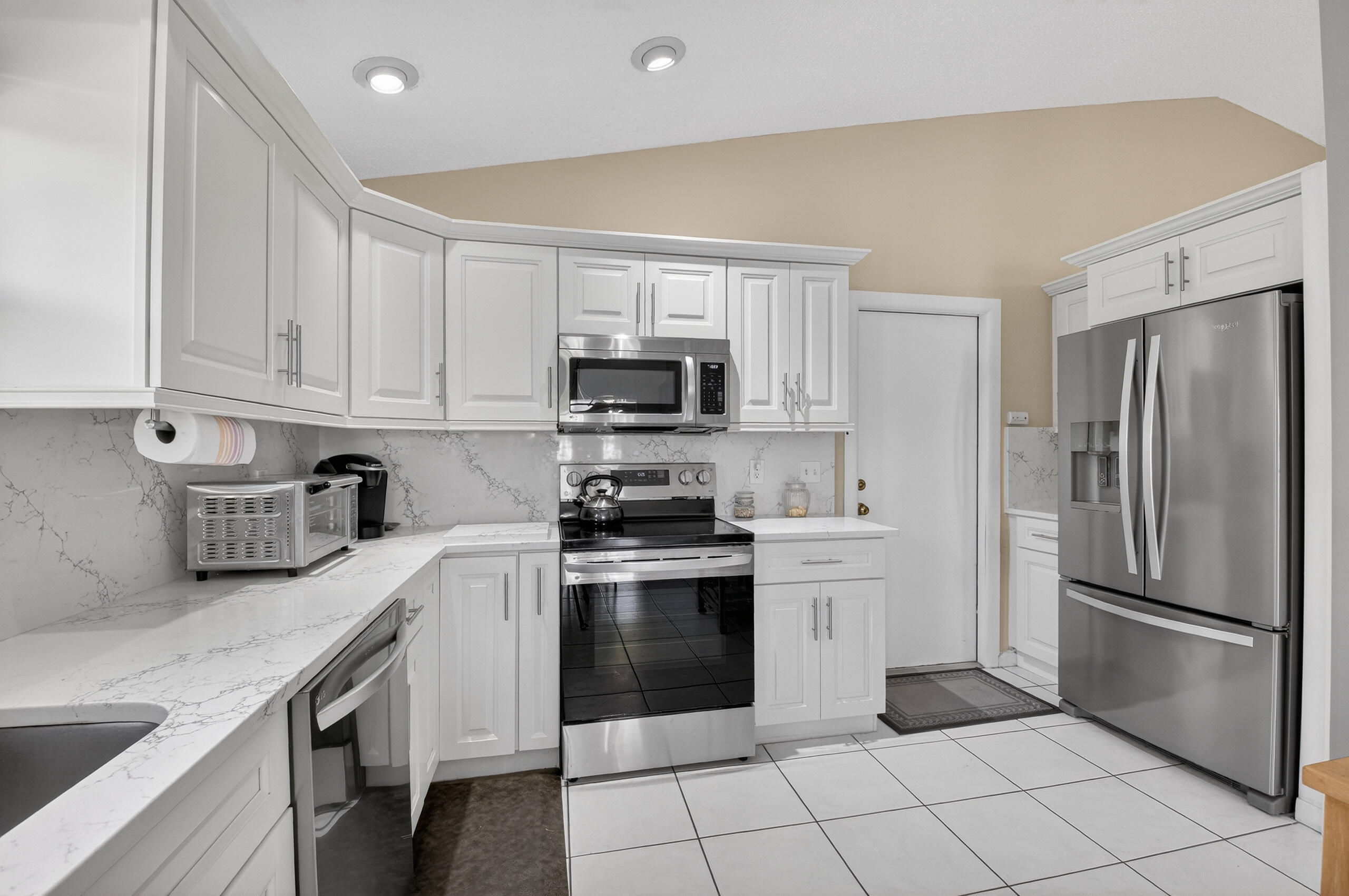 2601 Northwest 15th Street Delray Beach, FL 33445 - Photo 39 of 59 a kitchen with granite countertop a stainless steel appliances cabinets and a counter top space