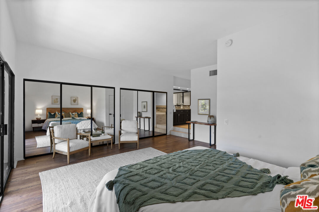 4549 Alla Road, Unit 3 Marina del Rey, CA 90292 - Photo 11 of 28 a bedroom with a bed window and walk in closet with wooden floor