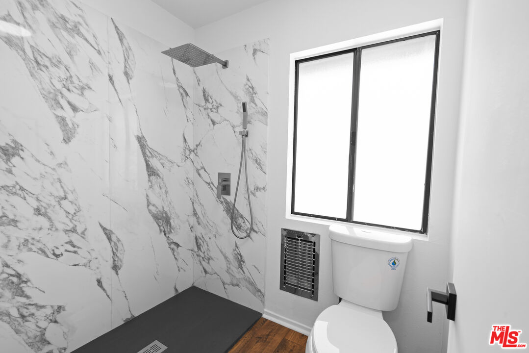 4549 Alla Road, Unit 3 Marina del Rey, CA 90292 - Photo 19 of 28 a white toilet sitting next to a shower curtain