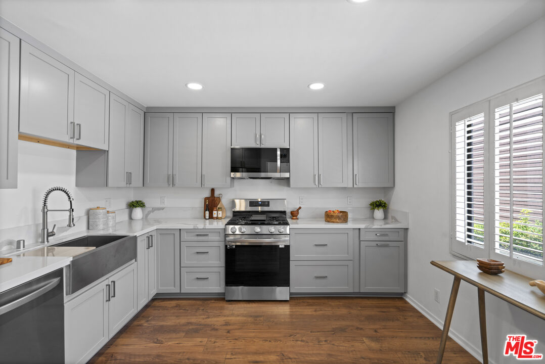 4549 Alla Road, Unit 3 Marina del Rey, CA 90292 - Photo 6 of 28 a kitchen with stainless steel appliances granite countertop a sink a stove a refrigerator cabinets and a window