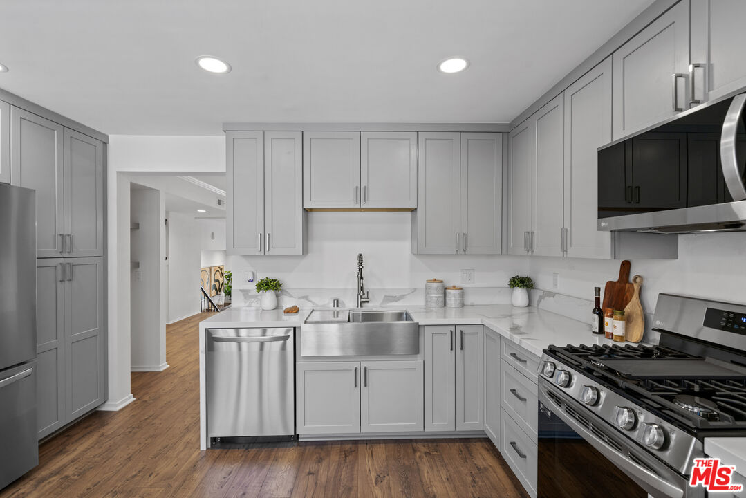 4549 Alla Road, Unit 3 Marina del Rey, CA 90292 - Photo 7 of 28 a kitchen with stainless steel appliances kitchen island granite countertop a sink dishwasher a stove a refrigerator and cabinets with wooden floor