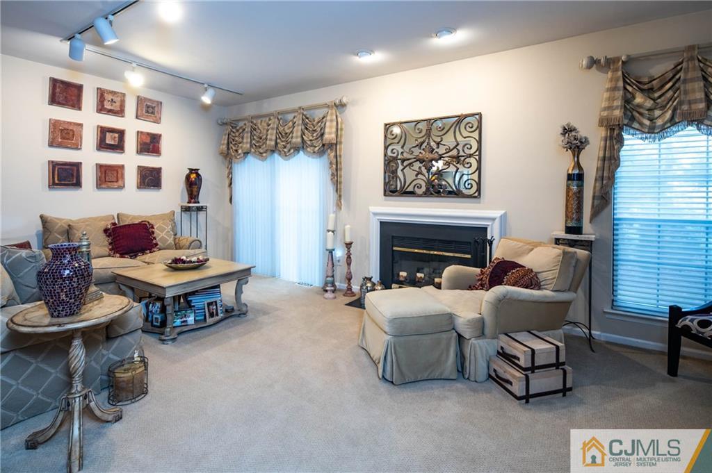 205 Timber Oaks Road, Unit 205 Edison, NJ 08820 - Photo 11 of 31 a living room with furniture and a fireplace