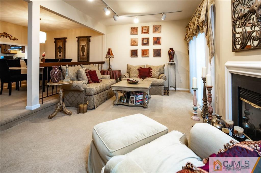 205 Timber Oaks Road, Unit 205 Edison, NJ 08820 - Photo 12 of 31 a living room with furniture fireplace and flat screen tv