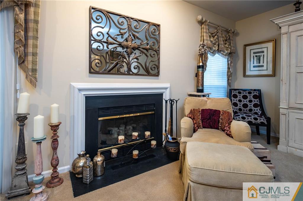 205 Timber Oaks Road, Unit 205 Edison, NJ 08820 - Photo 14 of 31 a living room with furniture and a fireplace