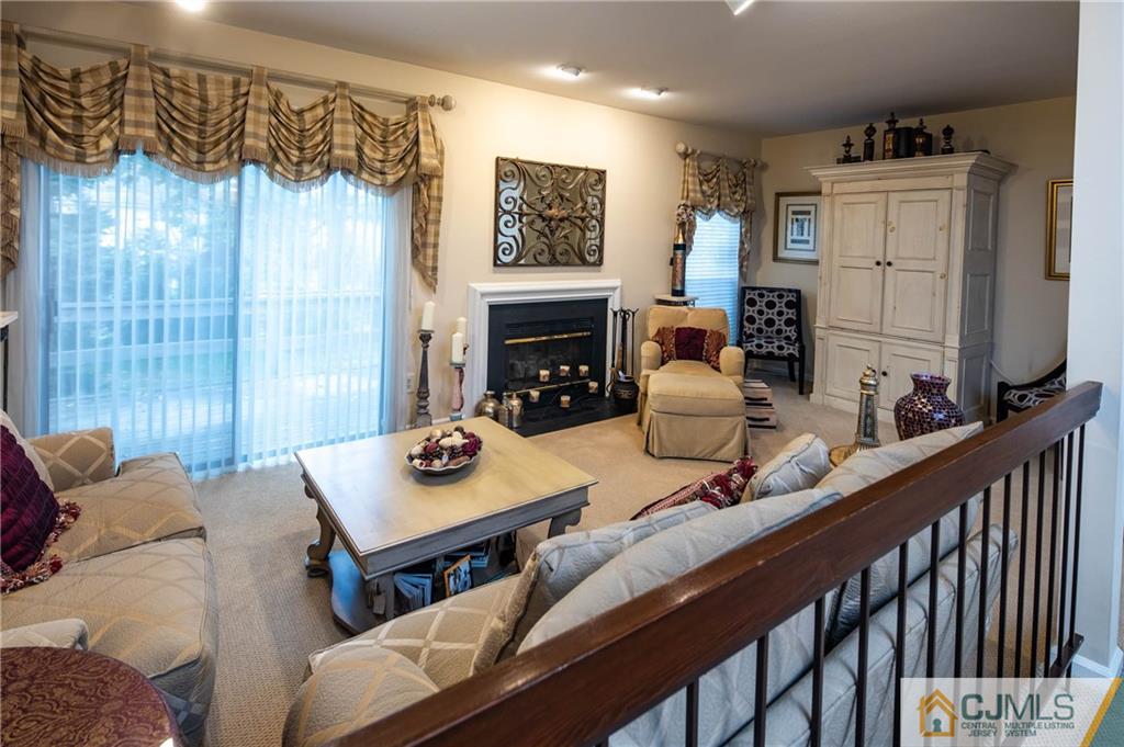 205 Timber Oaks Road, Unit 205 Edison, NJ 08820 - Photo 15 of 31 a living room with furniture a fireplace and a window