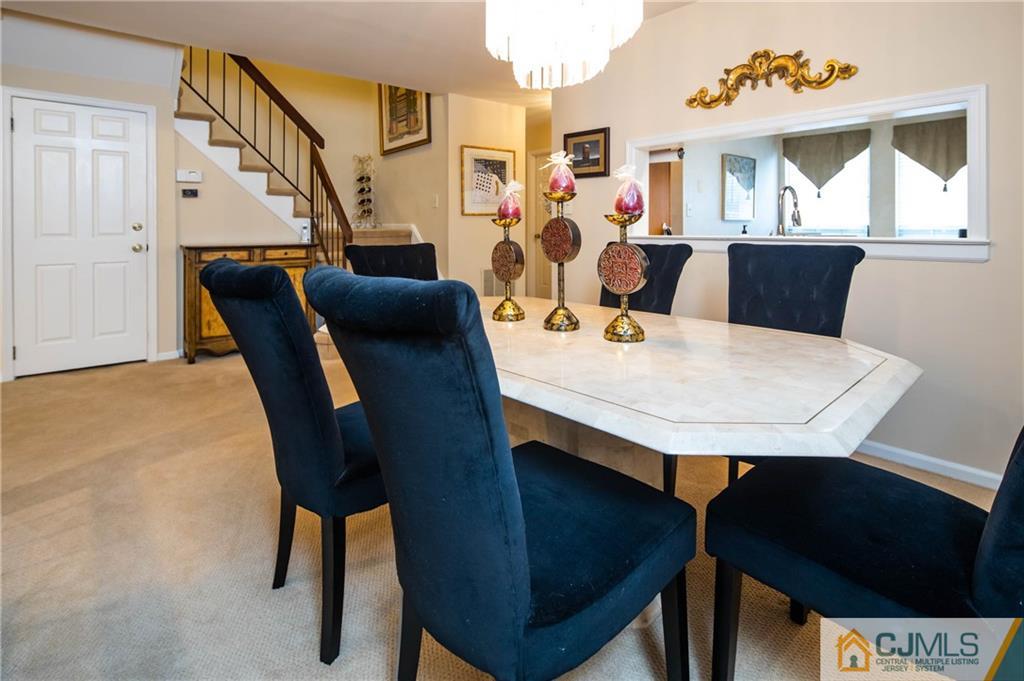 205 Timber Oaks Road, Unit 205 Edison, NJ 08820 - Photo 16 of 31 a view of a dining room with furniture and wooden floor