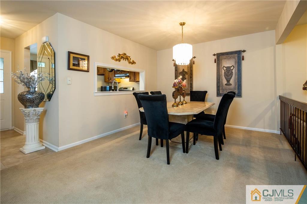 205 Timber Oaks Road, Unit 205 Edison, NJ 08820 - Photo 18 of 31 a view of a dining room with furniture and chandelier