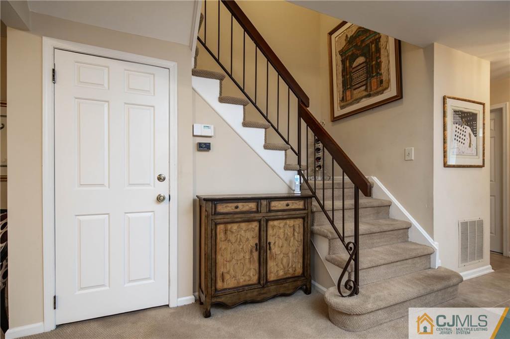 205 Timber Oaks Road, Unit 205 Edison, NJ 08820 - Photo 20 of 31 a view of staircase with lots of frames on wall and a window